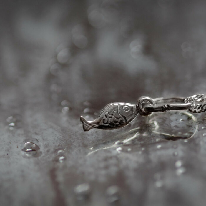 tiny fish pendant and necklace made of 925 sterling silver made for ocean and beach lovers that want to support marine biologists and ecologists doing research and conservation efforts internationally and in costa rica