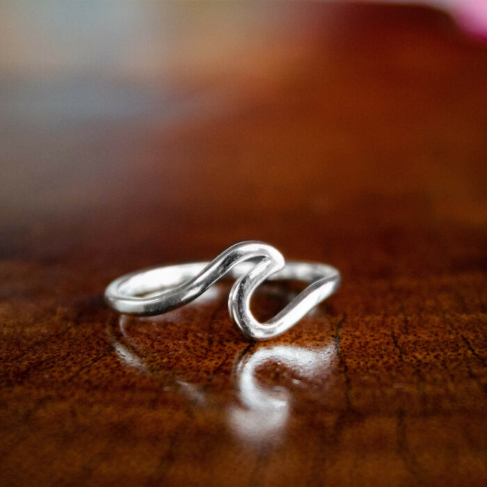 silver ring shaped like a tube wave to support marine conservation in costa rica